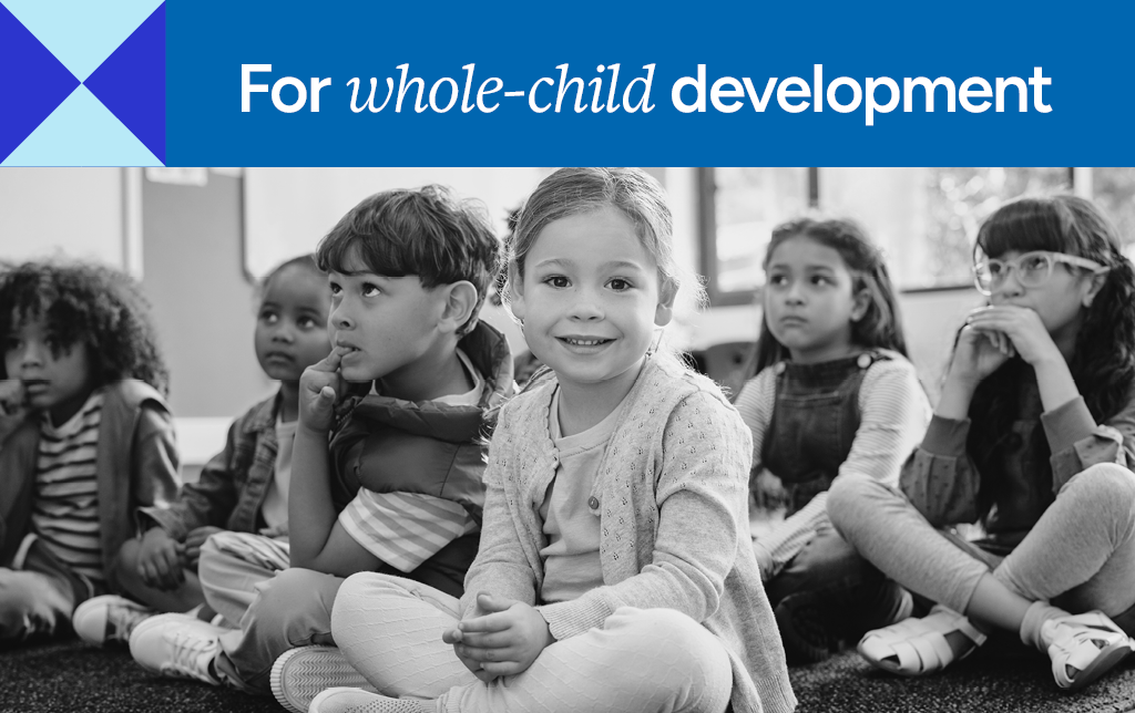 Classroom of smiling young children.